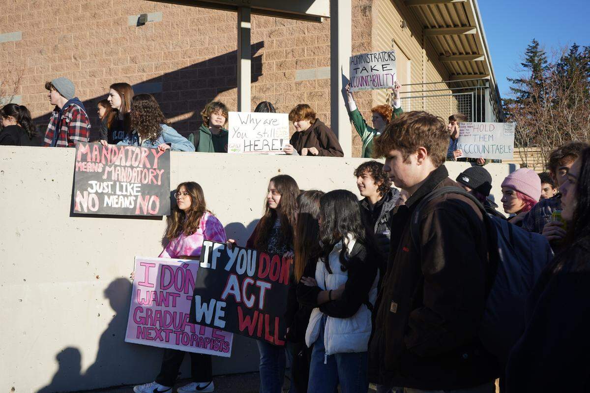 Hundreds of students, many holding signs, walked out of Squalicum High School Monday, Dec. 12, 2022, in Bellingham to protest after three Bellingham Public Schools assistant principals were issued criminal citations for failing to report a student’s sexual assaults.