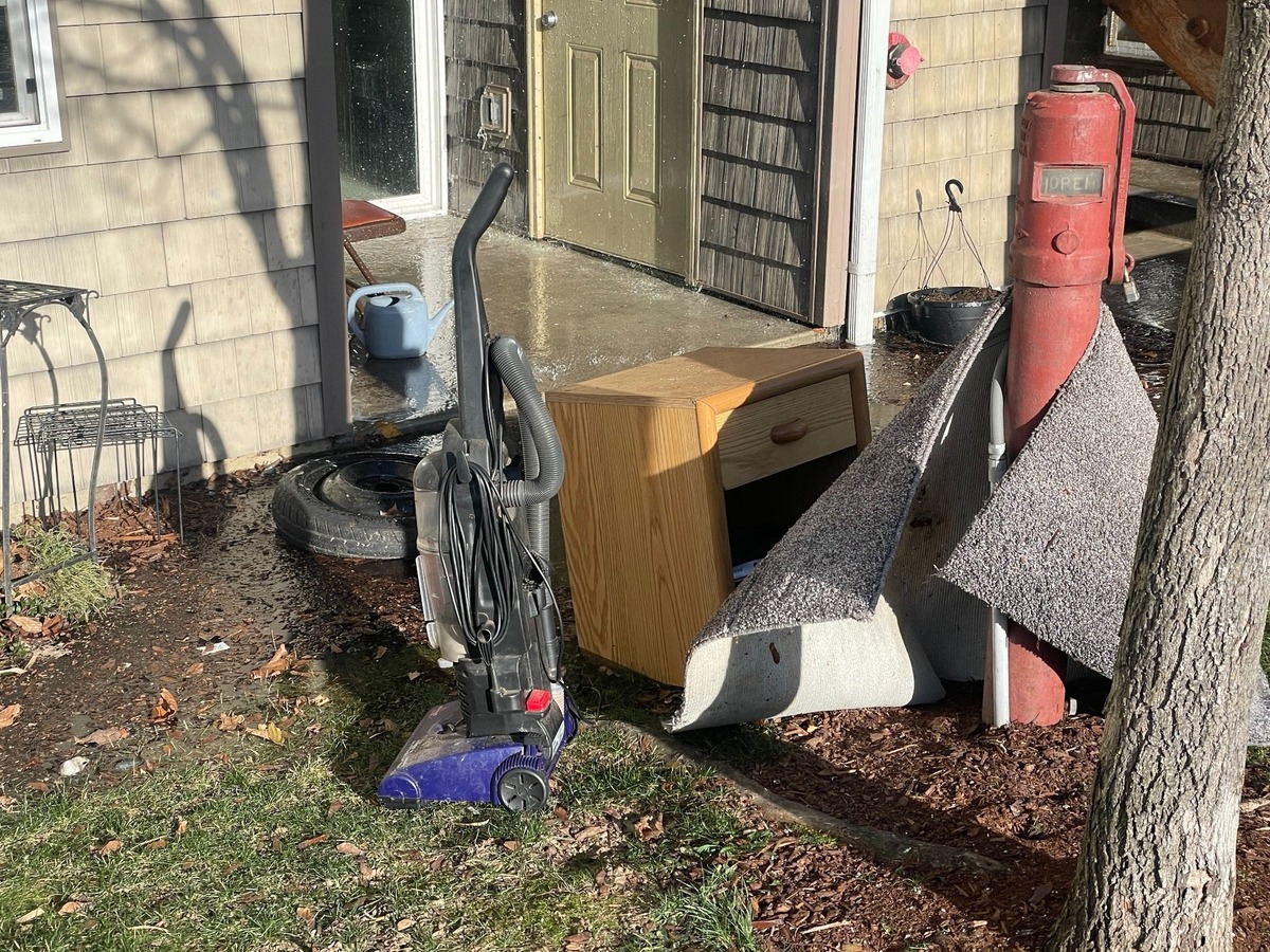 Meadow Wood townhomes residents moved their personal belongings outside after fire sprinklers burst and flooded units during January’s record freeze event in Bellingham, Wash.