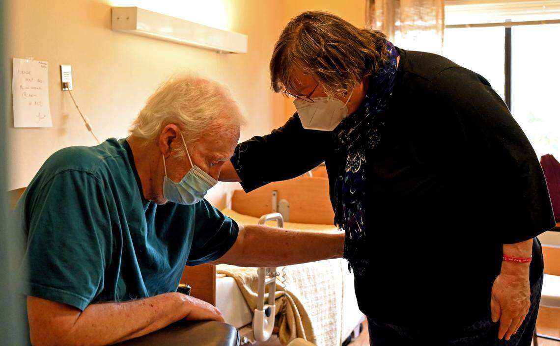 Suzanne Johnson hugs her husband, Paul, for the first time in over a year at the Mt. Baker Care Center on Thursday, April 1, in Bellingham. The COVID-19 pandemic kept them apart.