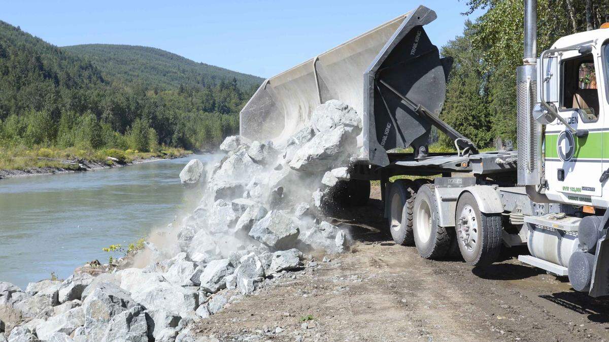 A Cowden side dump truck unloads rocks on the Sande-Williams levee on the Nooksack River near Deming in 2016. Cowden Inc.., which has been in Whatcom County for more than 75 years, was sold to a national firm.
