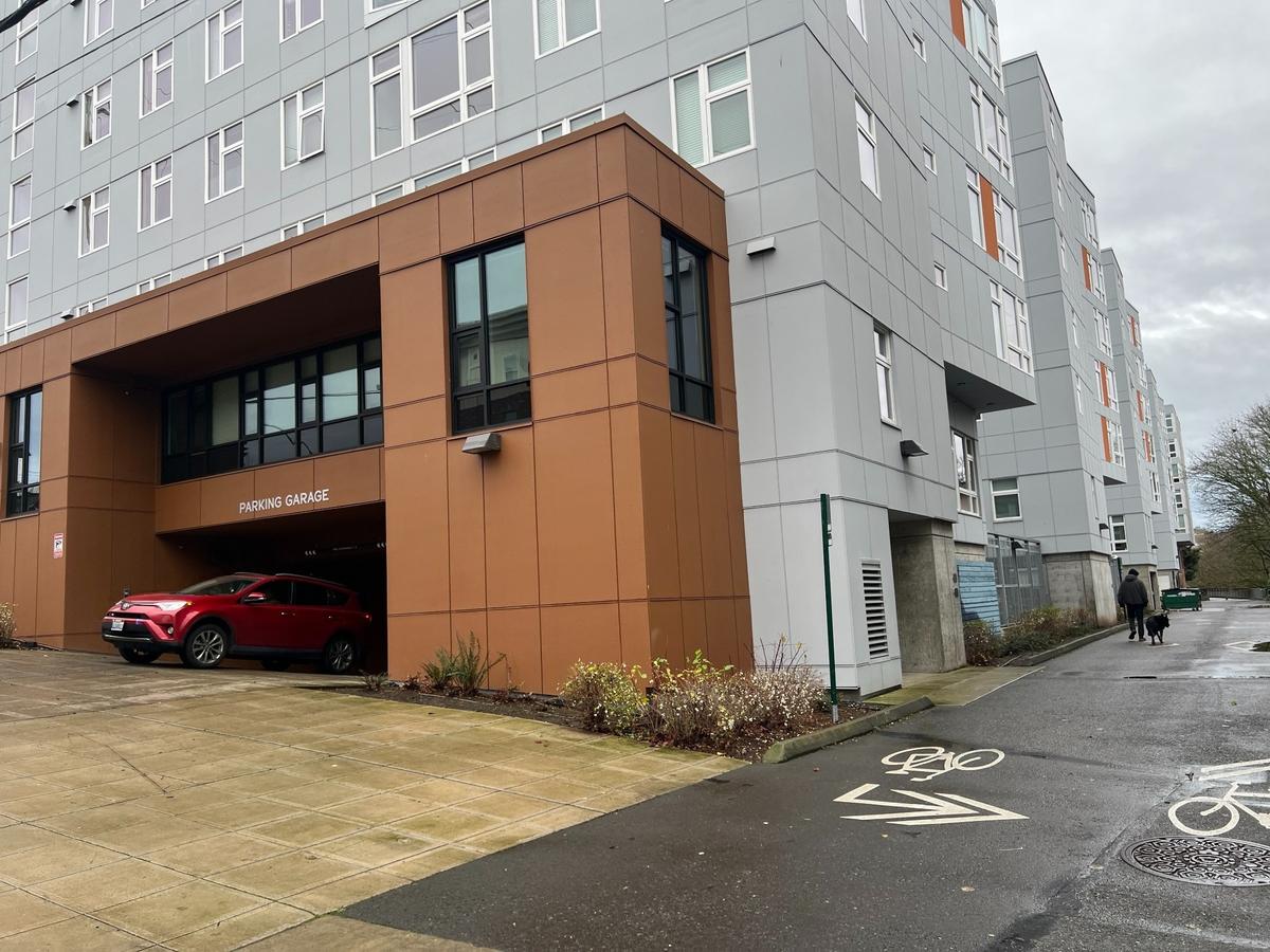 A car leaves the garage under Stateside apartments at the corner of State and Maple streets in Bellingham. Residents pay extra for a parking space and about half of them don’t have cars, city officials said.