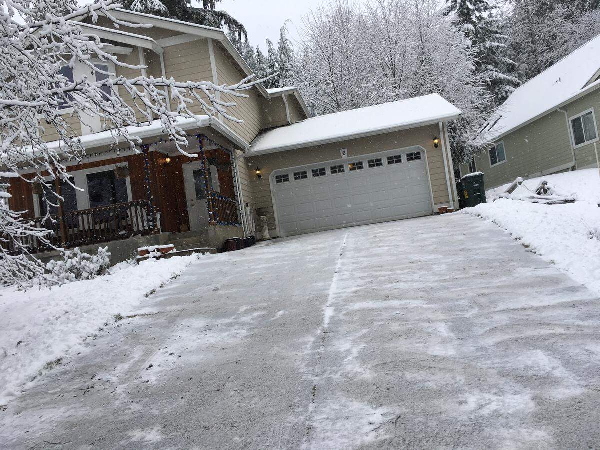 A driveway is shoveled and sanded in preparation for snow and ice. Sand helps give you traction.