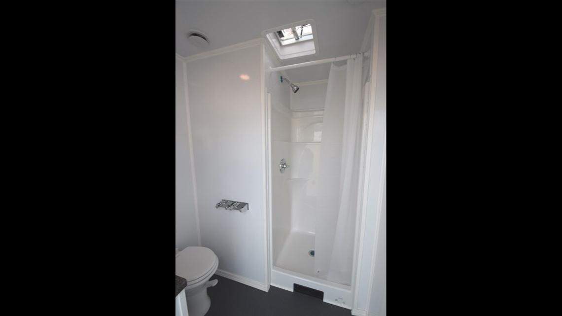 A unit inside the Lighthouse Mission shower trailer has a toilet, sink and shower. Up to 20 people can use the mobile shower service in about three hours.