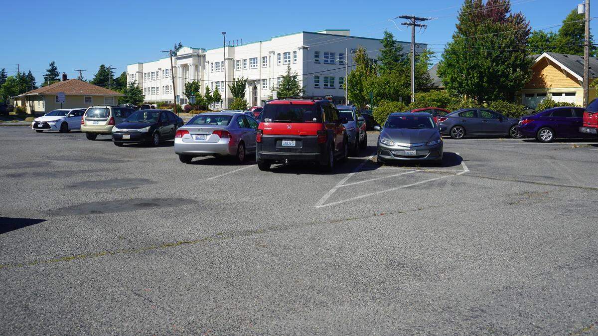 Cars are parked in a lot at the corner of C Street and Halleck Street on Aug. 16, 2023, in Bellingham, Wash. The city-owned lot is the site of a proposed affordable homeownership project.