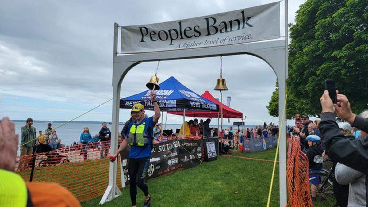 Birch Equipment’s team kayaker is first to ring the bell at Marine Park in Fairhaven during the Ski to Sea race Sunday, May 29.