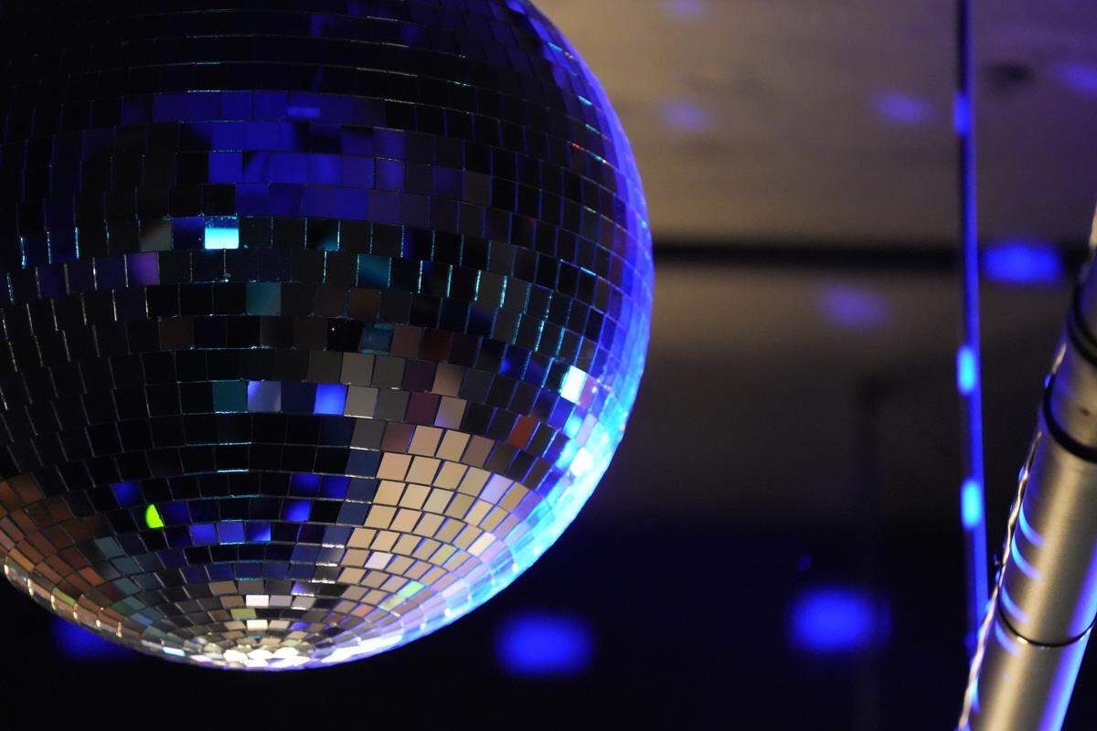 Blue lights reflect off a disco ball during an open house celebration on Oct. 2.