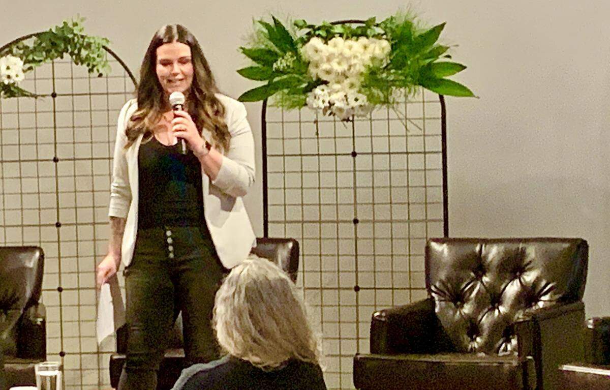 Event organizer and Her Connection Hub founder Heather Simpson warms up the crowd prior to introducing panelists.