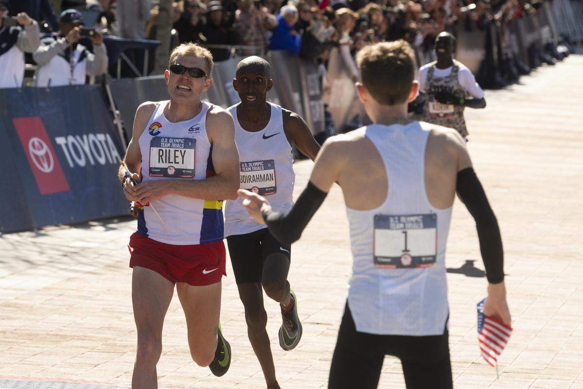 Second place finisher Jacob Riley, is followed by third place finisher Abdi Abdirahman as as first place finisher Galen Rupp greets them at the finish line during the U.S. Olympic marathon trials, Saturday, Feb. 29, 2020, in Atlanta. Riley, who earned a berth in the 2020 Olympics, graduated from Sehome High School.