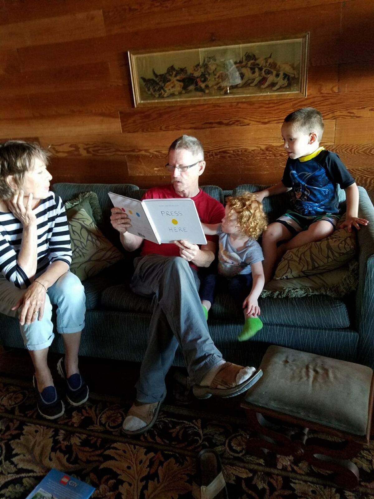 Don Alderson, second from left, reads to his grandchildren Charlie, right, and Ellyse, while his longtime girlfriend Mayrus Helberg listens on in 2016 at a cabin in Blaine. Alderson was killed in October 2018.