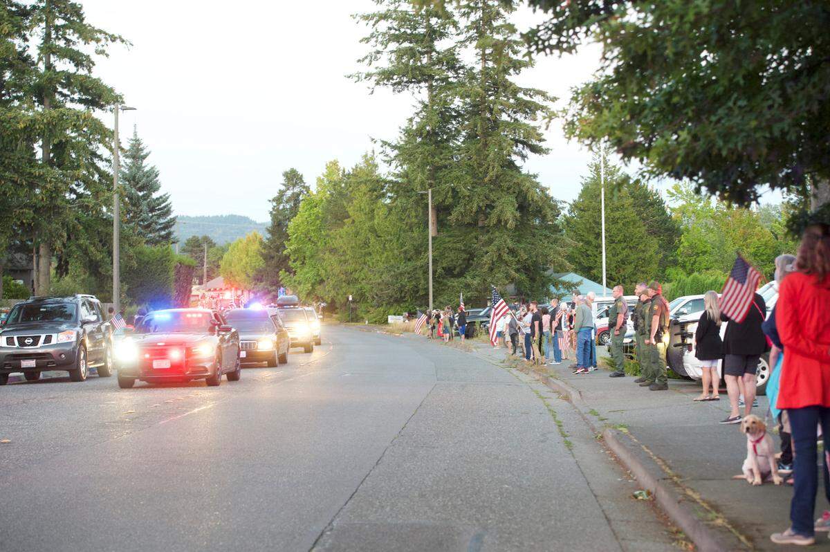 People line the street to honor U.S. Marines Lance Cpl. Jack-Ryan Ostrovsky during a Monday, Aug. 24, procession along the route from Interstate 5 to Westford Funeral Home in Bellingham. Ostrovsky was killed during a training exercise in July.