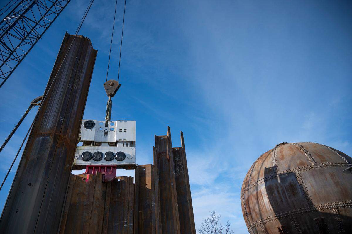 Construction crews use a crane to drive pilings at the future site of 94 condominium units on the waterfront in December in Bellingham.