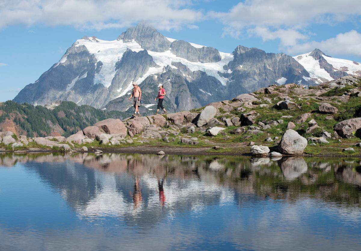 Hikers walk along the Artist Ridge Trail that offers fabulous views of Mount Baker and Mount Shuksan.