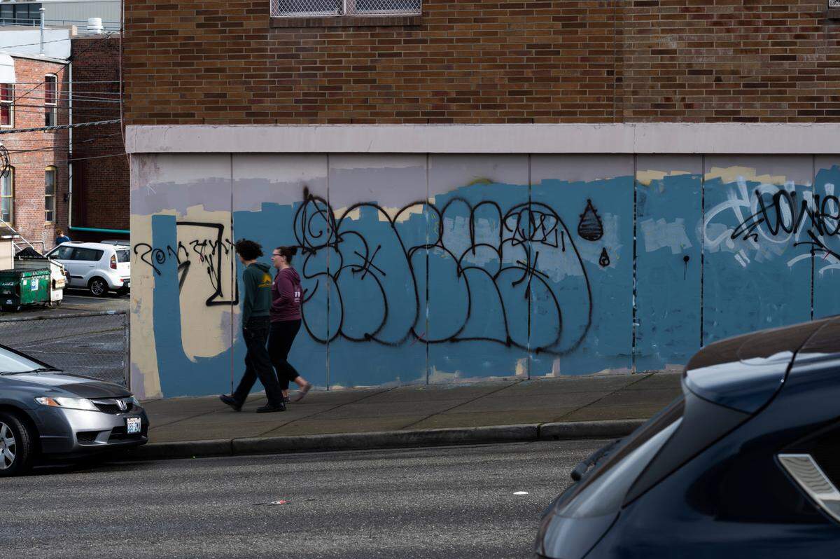 Graffiti covers a wall on East Chestnut Street on Thursday, April 21, 2022, in downtown Bellingham. The city is using $30,000 of its federal pandemic-relief funds for the Downtown Bellingham Partnership to bolster its landscaping crew and turn its focus toward graffiti reporting and removal.