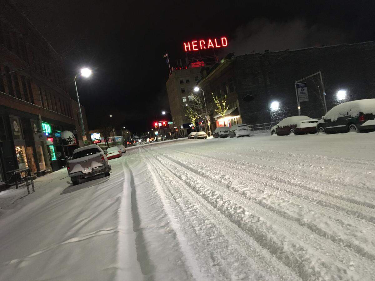 A few drivers made their way along North State Street in downtown Bellingham about 4 a.m. Jan. 15 before crews were able to plow many streets.