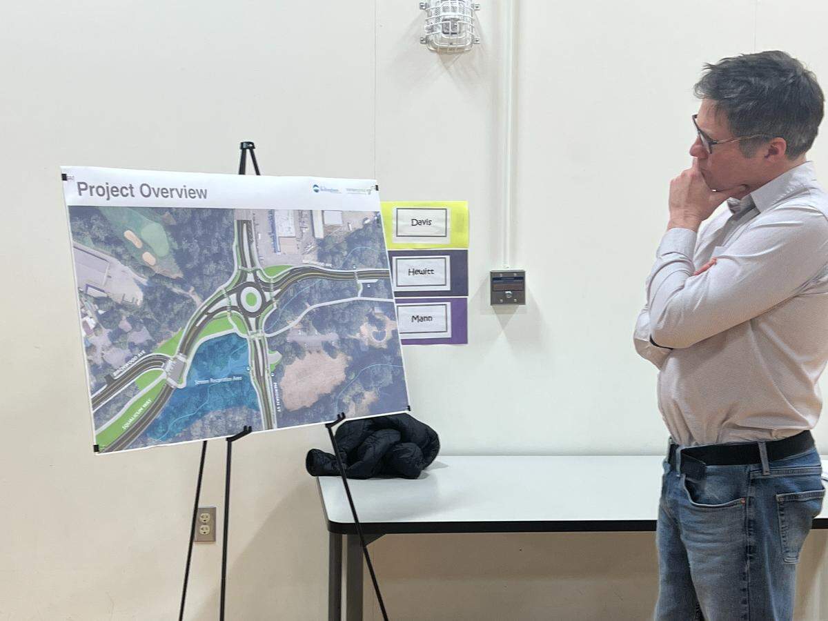 City of Bellingham engineer Freeman Anthony examines a drawing of the proposed Meridian Street-Birchwood Avenue roundabout during an open house March 4 at Parkview Elementary School in Bellingham.