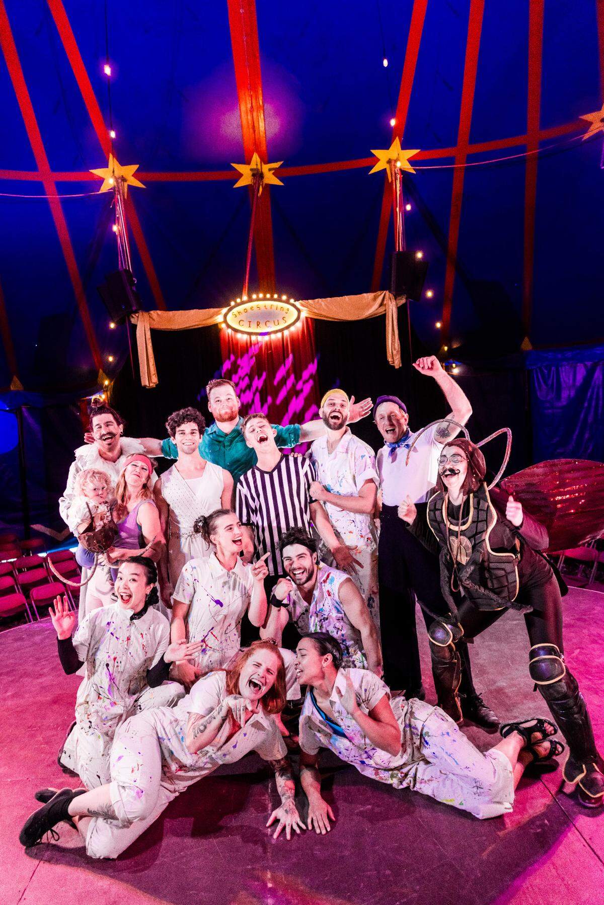 The 2025 cast of Shoestring Circus poses for a photo under the big top.