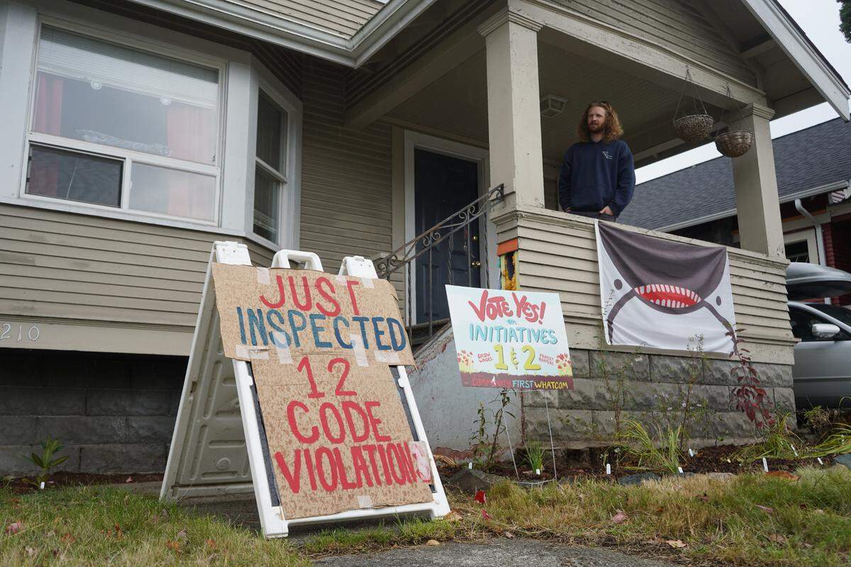 Aidan Hersh stands on the porch at 1210 Ellis Street on Sept. 27, 2023, in Bellingham, Wash. The Lakeway Realty rental property was found to have 12 code violations upon inspection. Some of the issues have been ongoing for years.