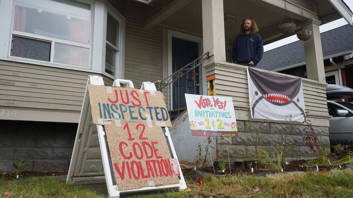 Aidan Hersh stands on the porch at 1210 Ellis St. in September 2023, after the Lakeway Realty rental property was found to have 12 code violations.