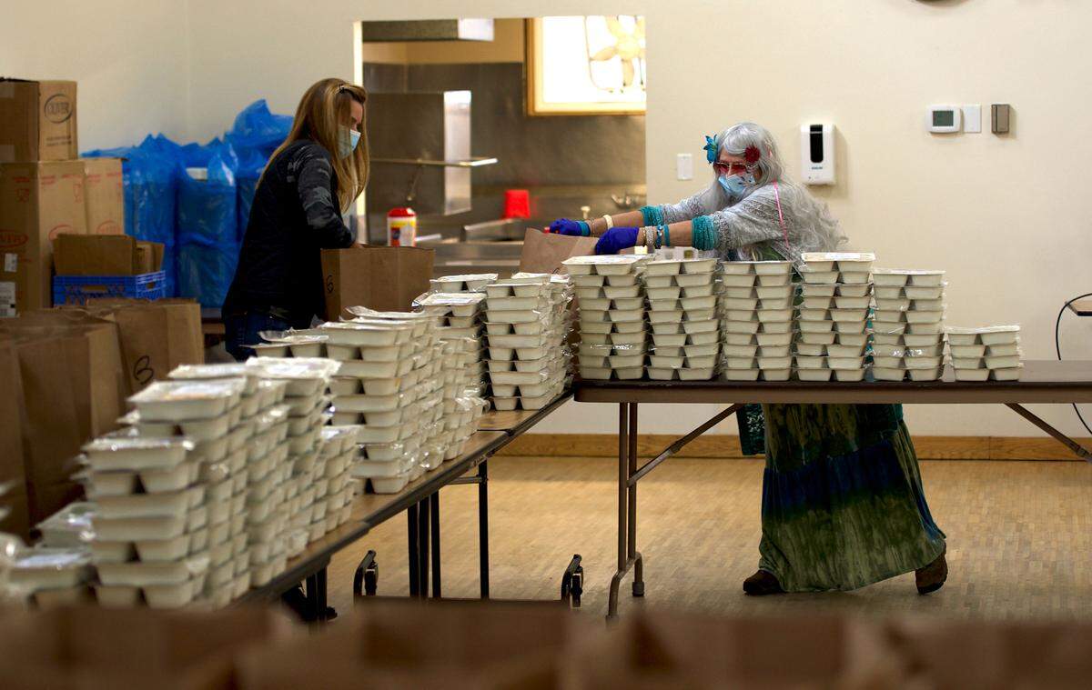 Volunteers for the Whatcom Council on Aging package meals to be distributed to seniors on Wednesday, Oct. 28, at the Bellingham Senior Activity Center in Bellingham.