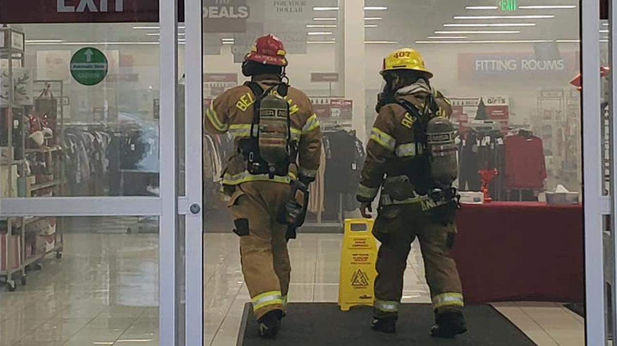 Bellingham firefighters work to clear smoke from the Burlington Coat Factory on Meridian Street Wednesday afternoon, Nov. 3, after a fire, believed to be started by a shoplifter, was extinguished.