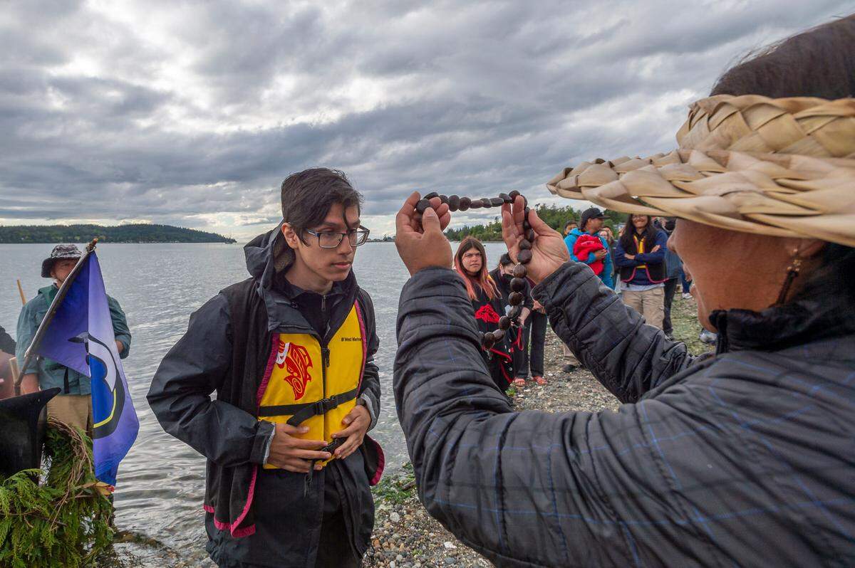 Paddlers are welcomed to the Gathering of the Eagles canoe landing celebration at the Lummi Stommish grounds on Friday afternoon May 27 on the Lummi Reservation in Whatcom County.