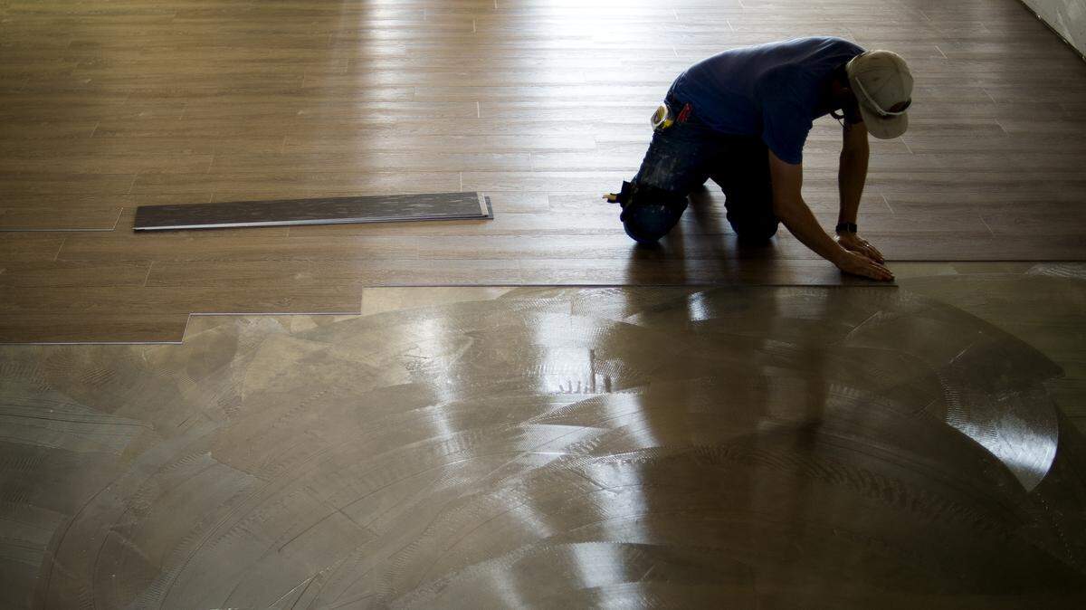 Roman Vetkov, owner of Pristine Interiors, installs a new floor in Burnt Ends on Wednesday in Lynden. The restaurant plans to open on Aug. 6.