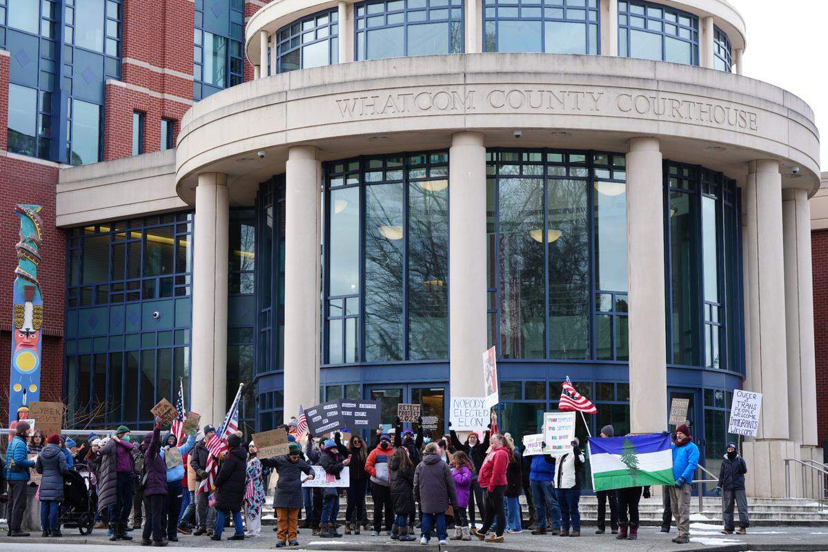 About 150 people marched to the Whatcom County Courthouse from the Federal Building in downtown Bellingham.