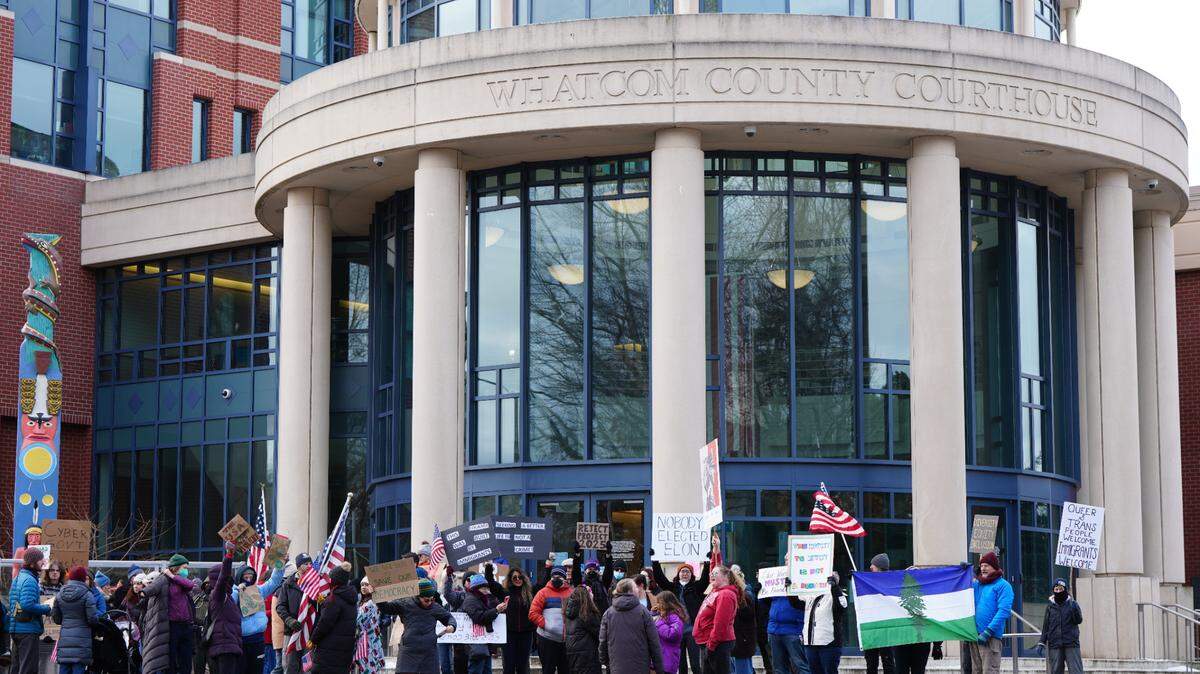 About 150 people marched to the Whatcom County Courthouse in downtown Bellingham on Wednesday to protest President Donald Trump’s administration.