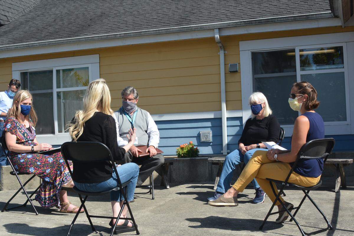U.S. Sen. Patty Murray, second from right, chats with preschool parents and staff at the YMCA’s child-care center in the Barkley neighborhood of Bellingham on Sept. 7.