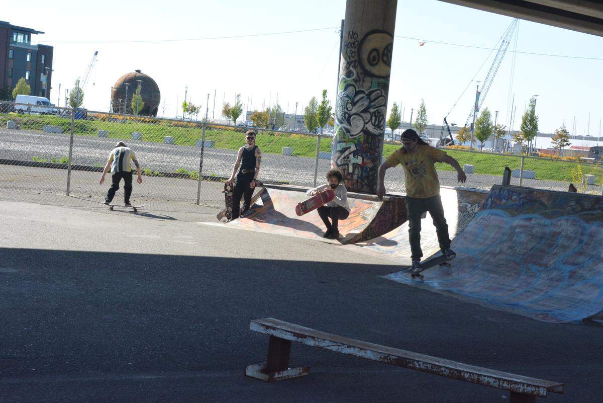 Skaters at the “DIY” skate park under the Roeder Avenue bridge from the waterfront to downtown Bellingham. Waypoint Park and the iconic Acid Ball are in the background