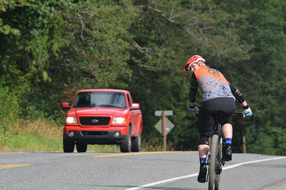 A mountain biker checks traffic as he gets set to cross Samish Way near Galbraith Lane on Wednesday.