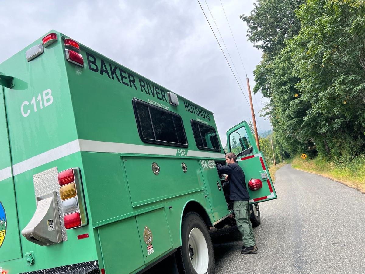 A member of the Baker River Hotshots, an elite U.S. Forest Service fire crew, checks gear Tuesday on one of their trucks on Blue Canyon Road at the southeast end of Lake Whatcom.