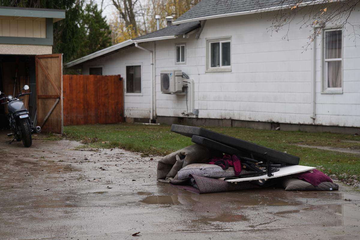 Water and silt-soaked belongings were pulled out of a garage after being flooded by the Nooksack River floodwaters on December 12, 2025, in Bellingham, Wash.