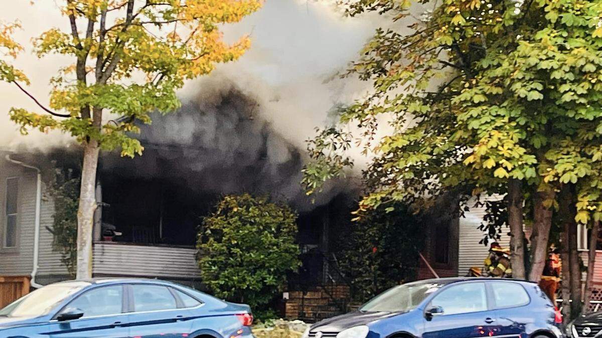Smoke pours from a house at 1134 Ellis St. in Bellingham, Wash., about 7 a.m. Sunday, Sept, 17, 2023. One person was hurt in the fire, Bellingham Fire Department officials said.