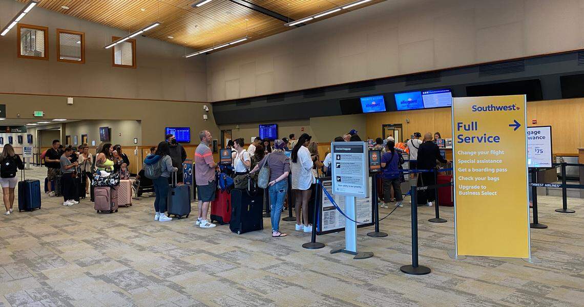 Passengers wait for boarding passes before peak times at the Bellingham International Airport on Thursday, June 30.
