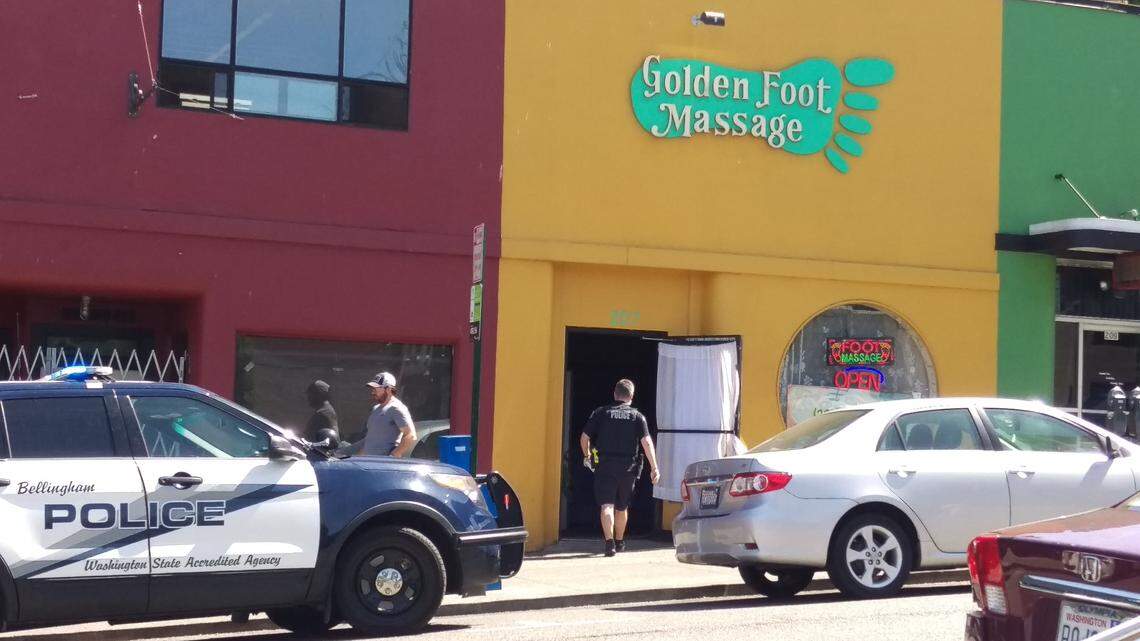 FBI agents and members of the Bellingham Police Gang Task Force enter the Golden Foot Massage parlor 207 E. Chestnut St. in Bellingham Thursday.