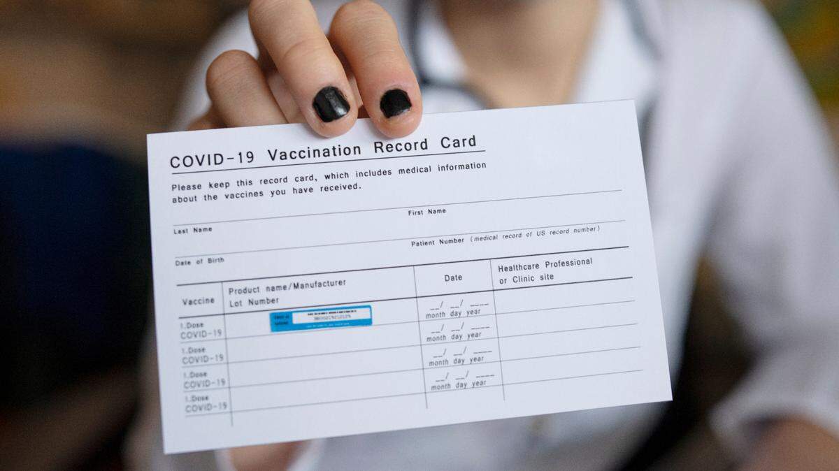 Close up of a COVID-19 vaccination record card.