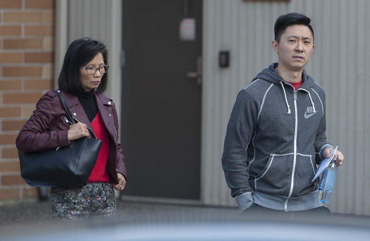 Carmen Kong and Matthew Kong leave Richmond Provincial Court in Richmond, B.C. Thursday, October 11, 2018. The pair were in court to support their husband and father Michael Kong, 61, in what turned out to be an unsuccessful bid for bail. Kong is accused of multiple human smuggling offenses.