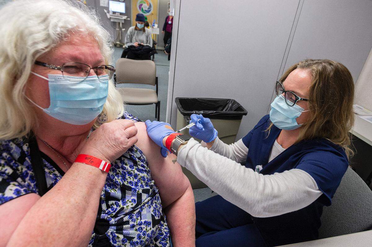 Evelyn Sturgeon of Everson is administered the second shot of the Pfizer COVID-19 vaccine by nurse Susan Spaniol on Saturday afternoon, Feb. 20, at PeaceHealth St. Joseph Medical Center in Bellingham. The vaccine clinic was held for hospital employees.