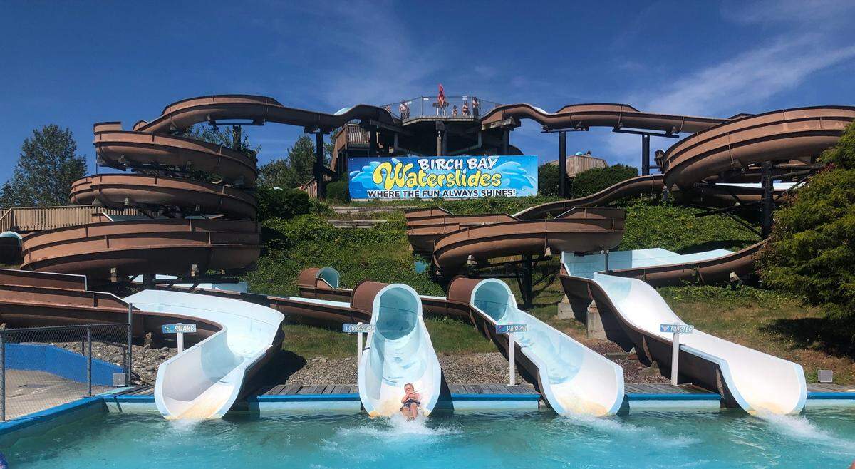 The Snake, left, Corkscrew, Hairpin and Twister water slides drop riders into a pool at Birch Bay Waterslides Saturday, Aug. 6.