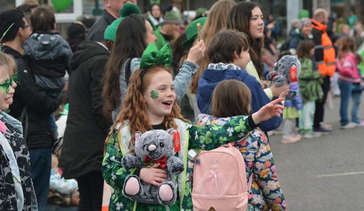 Drew James waves from the sidelines as the 16th annual St. Patrick’s Day Parade passes in downtown Bellingham.