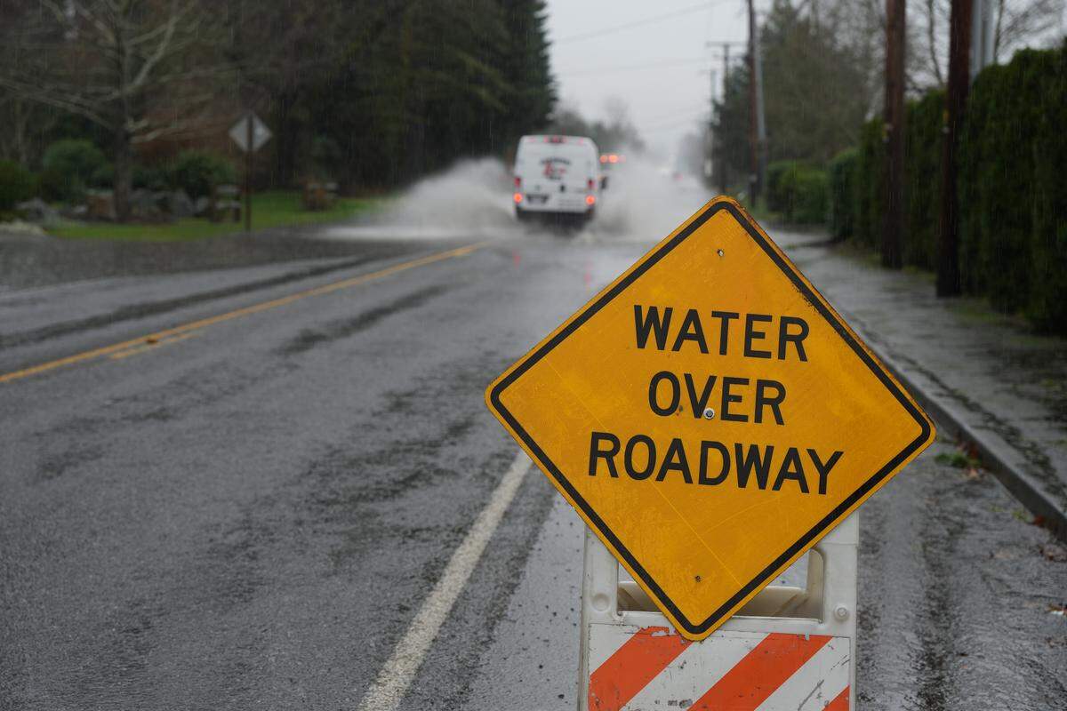 A van drove through water covering Smith Road on December 10, 2025, in Bellingham, Wash.