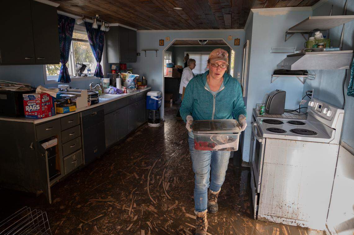 Erica Olson removes damaged things from her daughter’s Sumas home Friday, Nov. 19, after it was damaged by severe flooding earlier in the week.