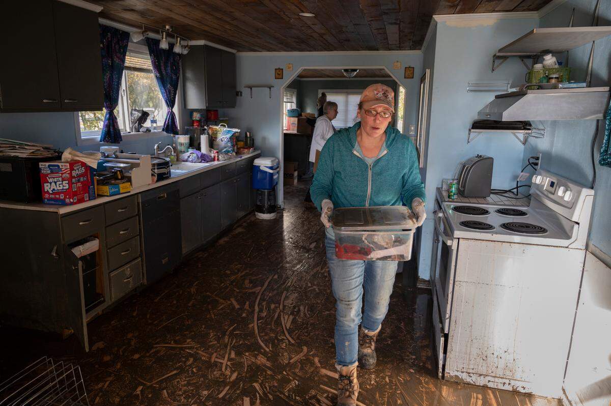 Erica Olson removes damaged things from her daughter’s Sumas home Friday, Nov. 19, after it was damaged by severe flooding earlier in the week.