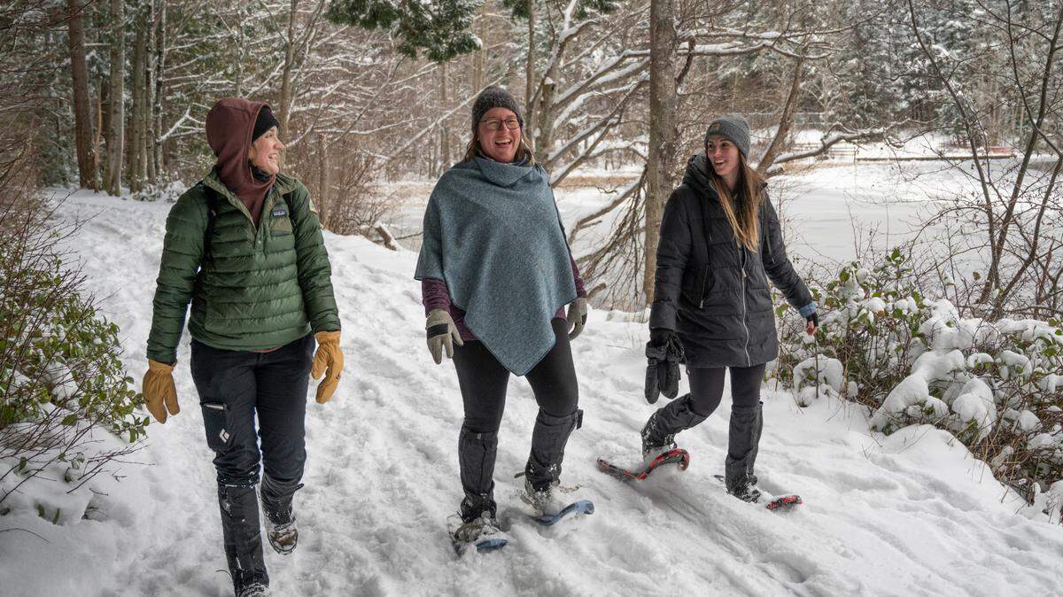 Annie Kent, left, Jessie Holland, middle, and Christina Valentine, right, walk and snowshoe around Lake Padden on Thursday, Dec. 30, in Bellingham. Whatcom County schools are on track to resume school Monday, Jan. 3, even as snow remains on the ground.