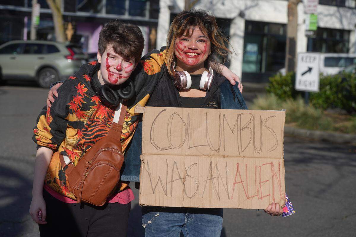 Adrian Ruben (left) and Johni Tom participate in Thursday’s student walkout.
