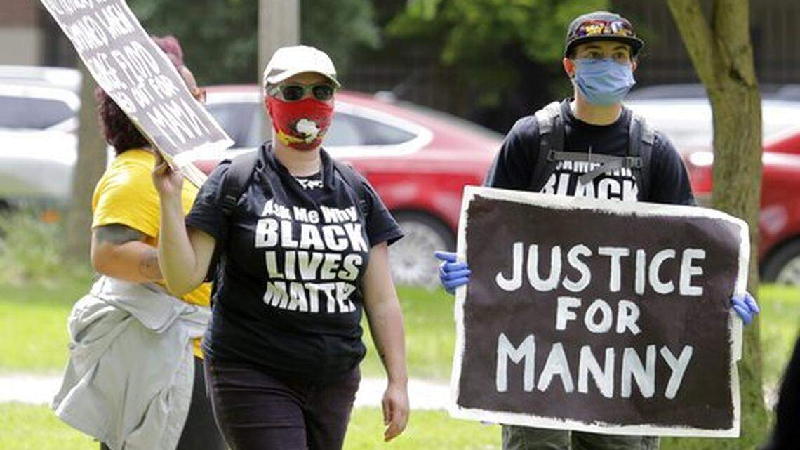 A protester holds a sign that reads “Justice for Manny” Friday, June 5, 2020, in Tacoma during a protest against police brutality and the death of George Floyd, a black man who died after being restrained by Minneapolis police officers on May 25. The Ellis family received a $4 million settlement in March 2022 from the Pierce County Sheriff’s Department, whose deputies were on the scene when Ellis died, with claims against the involved Tacoma officers still pending.