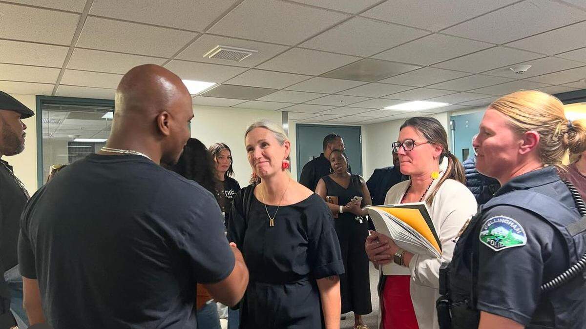 Bellingham, Wash., Mayor Kim Lund, center, greets DeVante Blow, left, at the Whatcom County Courthouse after a bail hearing in the the case of a hate crime attack against Blow’s son. At right is Police Chief Rebecca Mertzig.