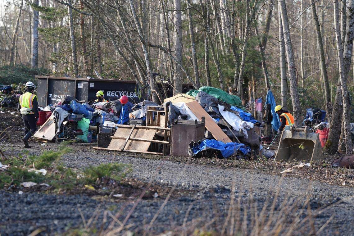 Crews stacked furniture and other large items in a pile at the encampment.