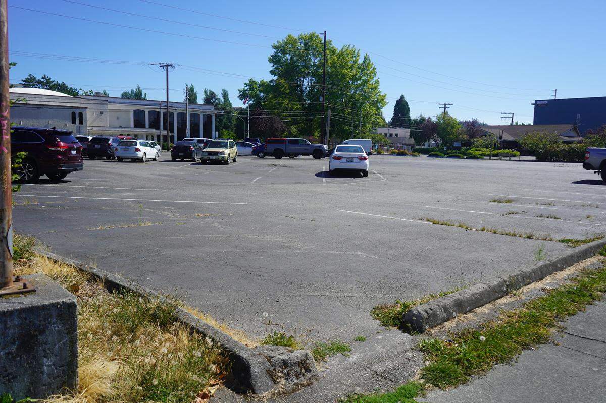 Cars are parked in a lot at the corner of C Street and Halleck Street on Aug. 16, 2023, in Bellingham, Wash. The city-owned lot is the site of a proposed affordable homeownership project.